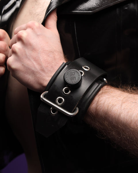 Closeup of Starting Rubber Restraint Wrist Restraint with metallic buckles and Monogrammed Rubber Elite Cap